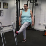 A woman kicking a walking frame during her fibromyalgia recovery
