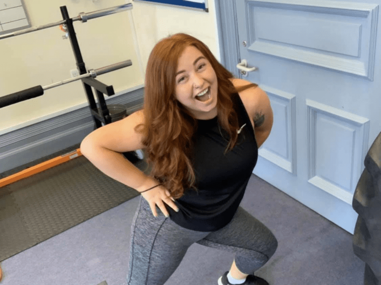A woman with red hair smiling