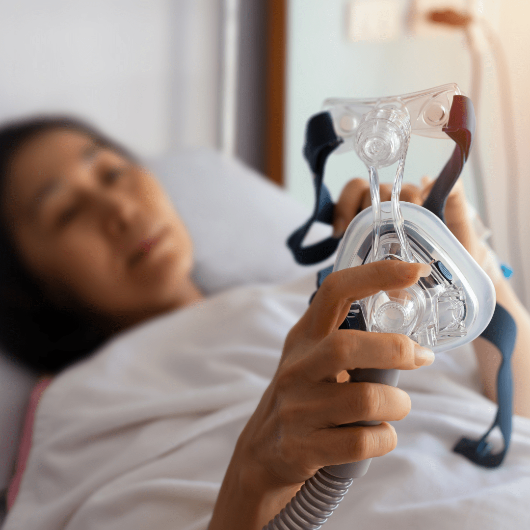 A woman holding a Cpap machine