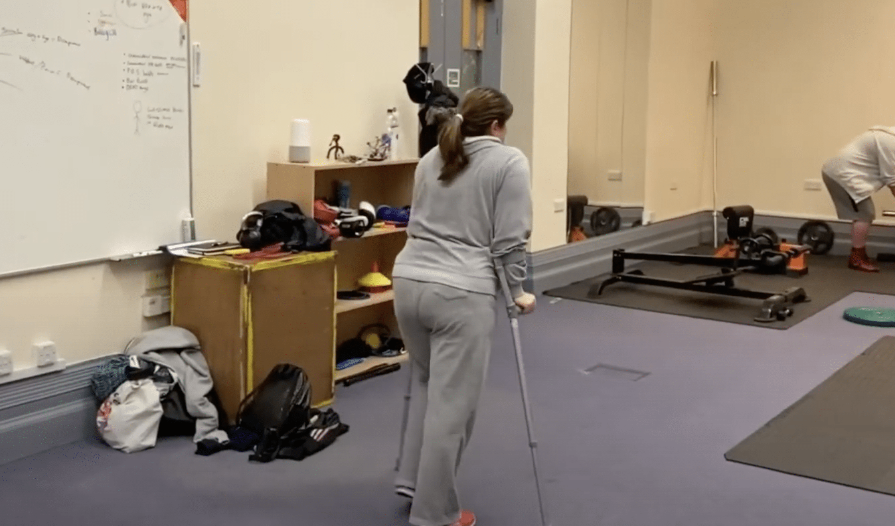 A woman wearing a grey track suit on her mobility programme