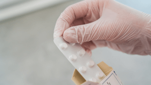A gloved hand holding the medication Amitriptyline