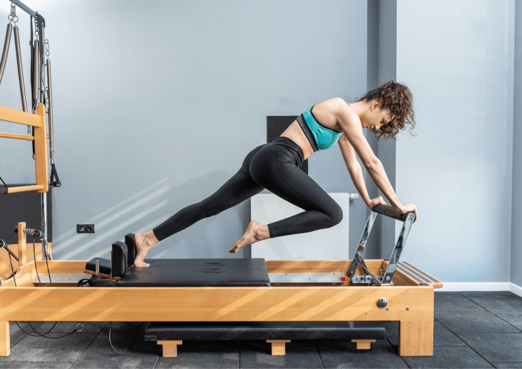 A woman on a pilates reformer