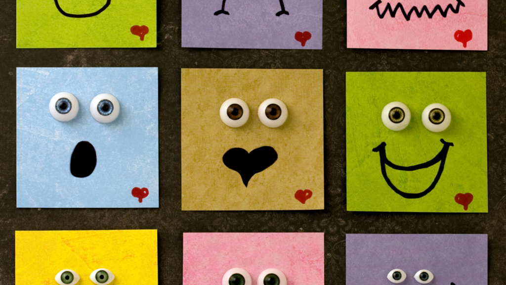Various square post it notes, all showing different emotions,: happy, sad, angry