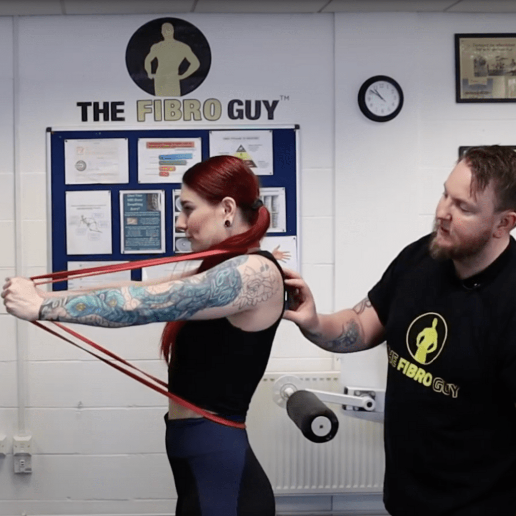 A woman with red hair exercising