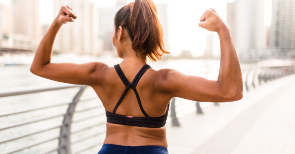 A woman flexing her back muscles