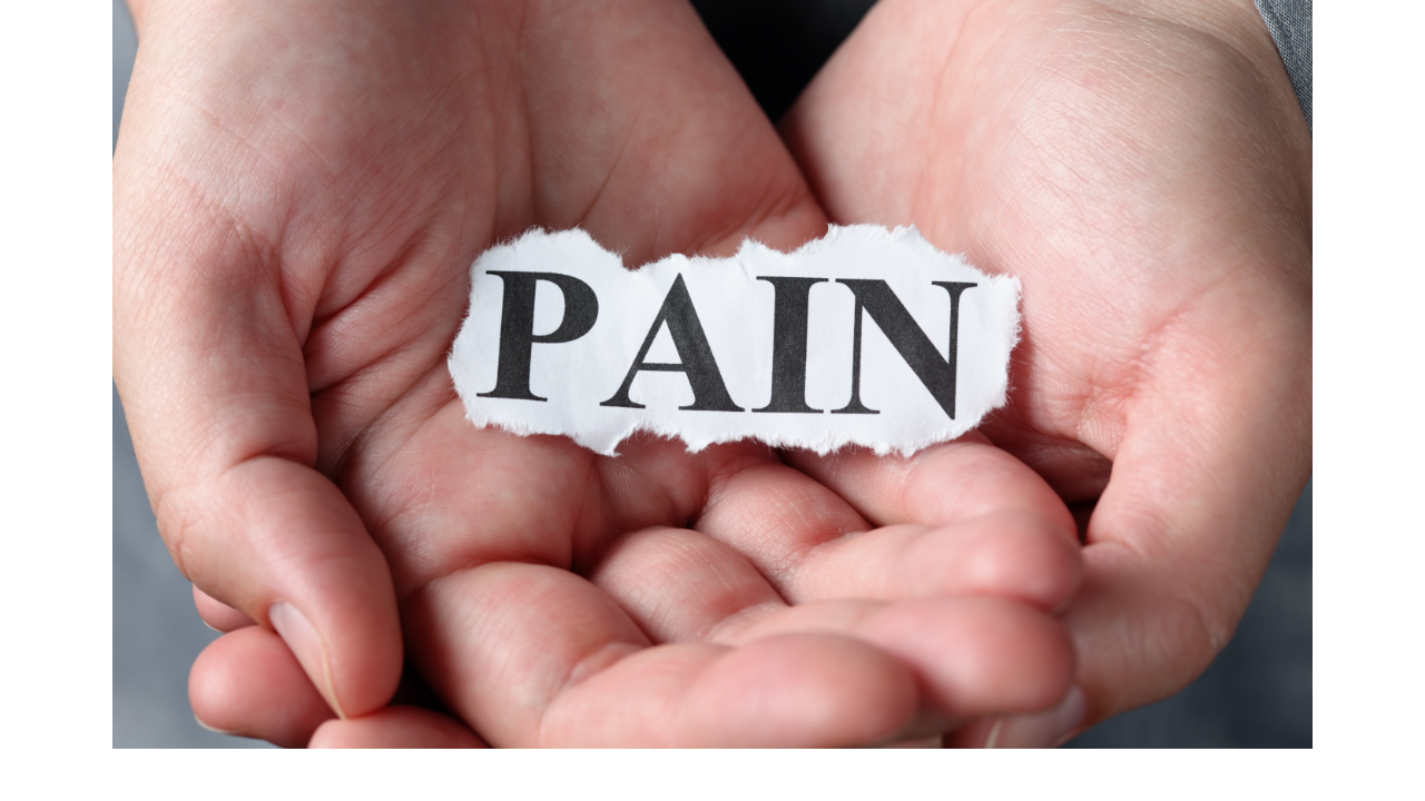 Woman's hands holding the word pain