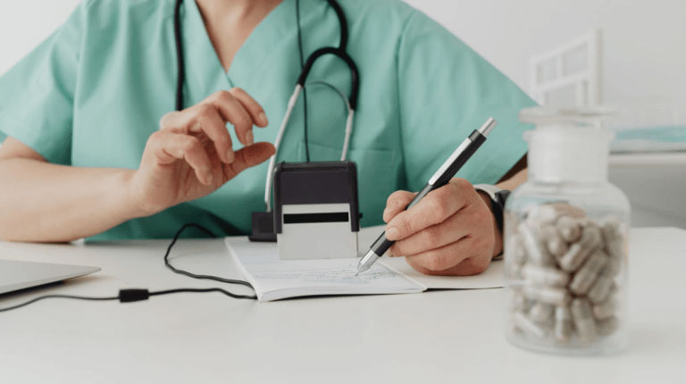 A doctor writing on a note pad