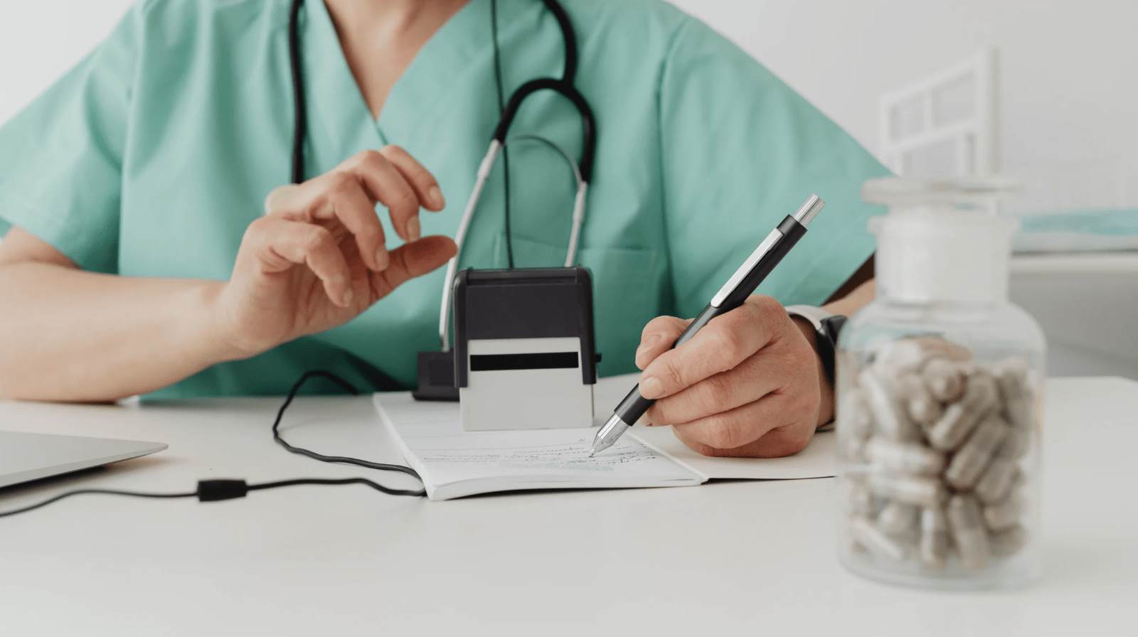 A doctor writing on a note pad