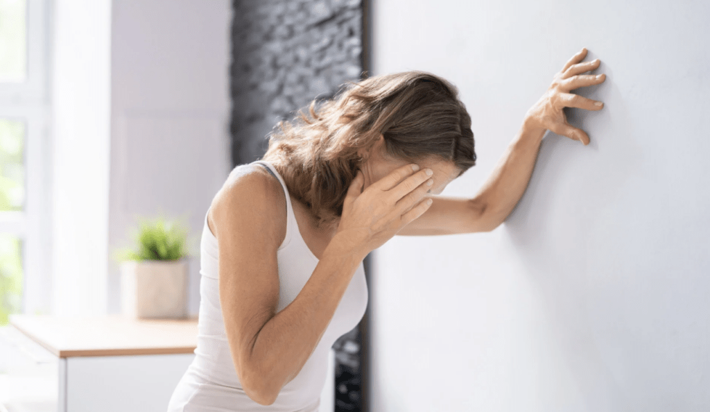 A woman struggling with dizziness