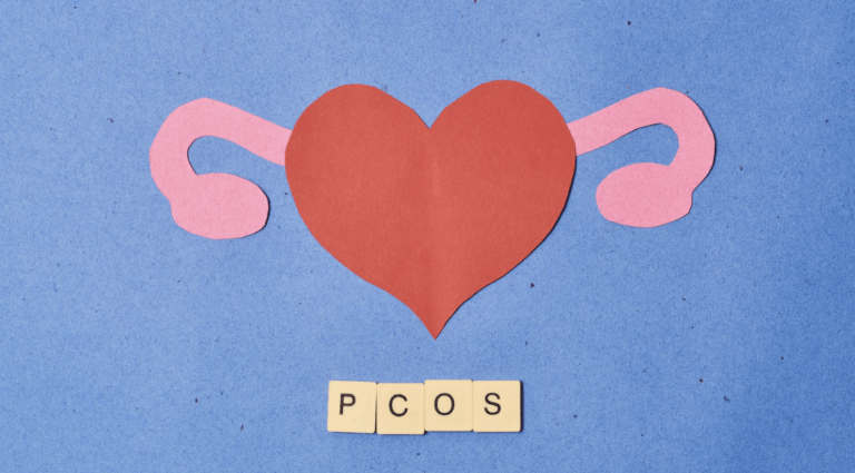 A hear with ovaries and scrabble tiles underneath reading PCOS
