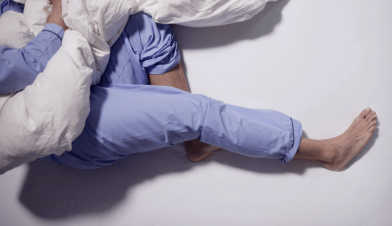 a pair of legs laid on a bed